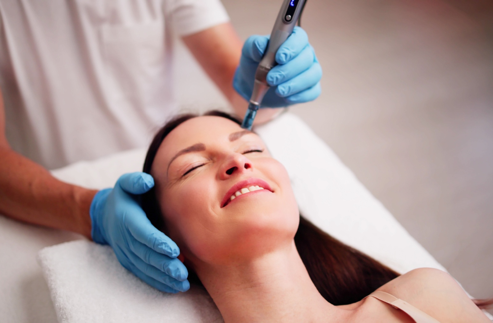 Close-up of a woman receiving a professional microneedling treatment to rejuvenate and enhance her skin's texture and appearance.